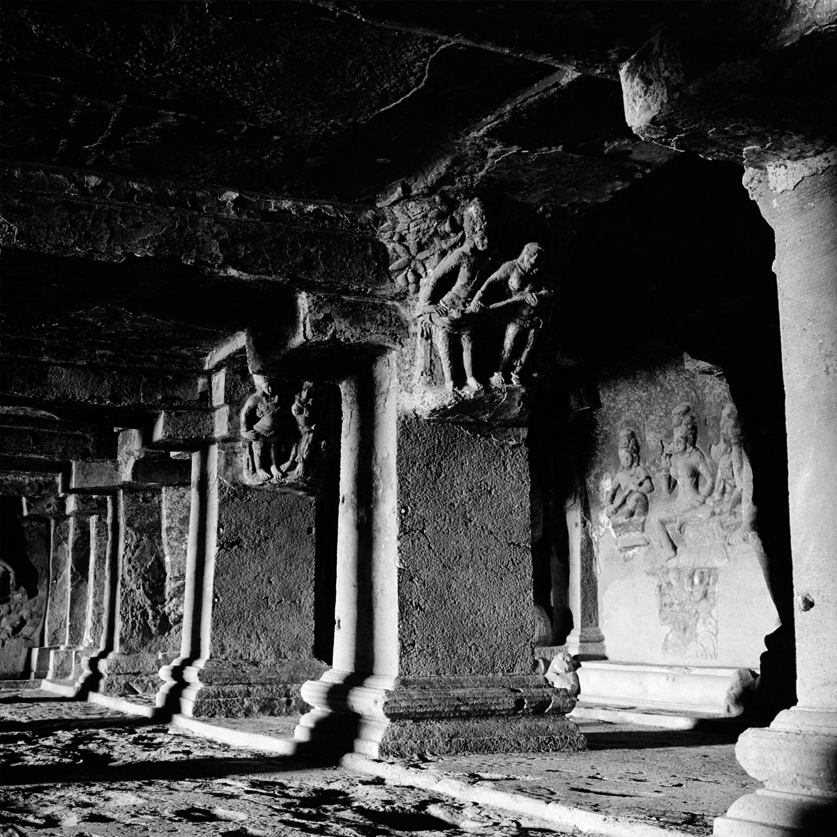 Shadowed colonnade in a cave temple, Ellora, Maharashtra.