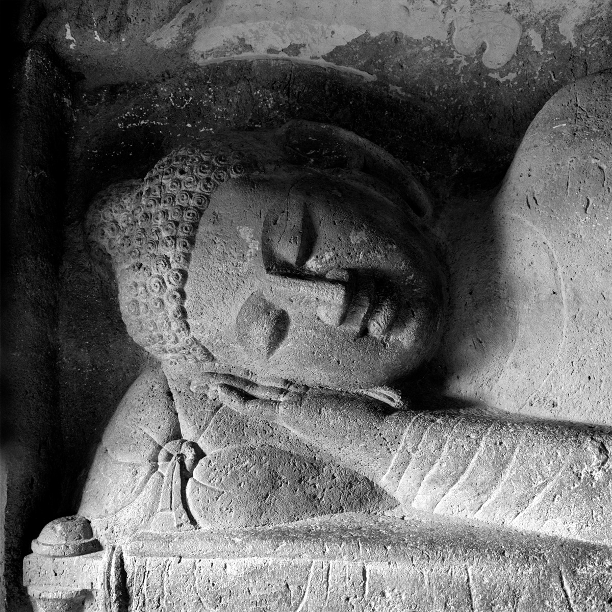 Sleeping Buddha relief in a cave temple at Ajanta, Maharashtra.