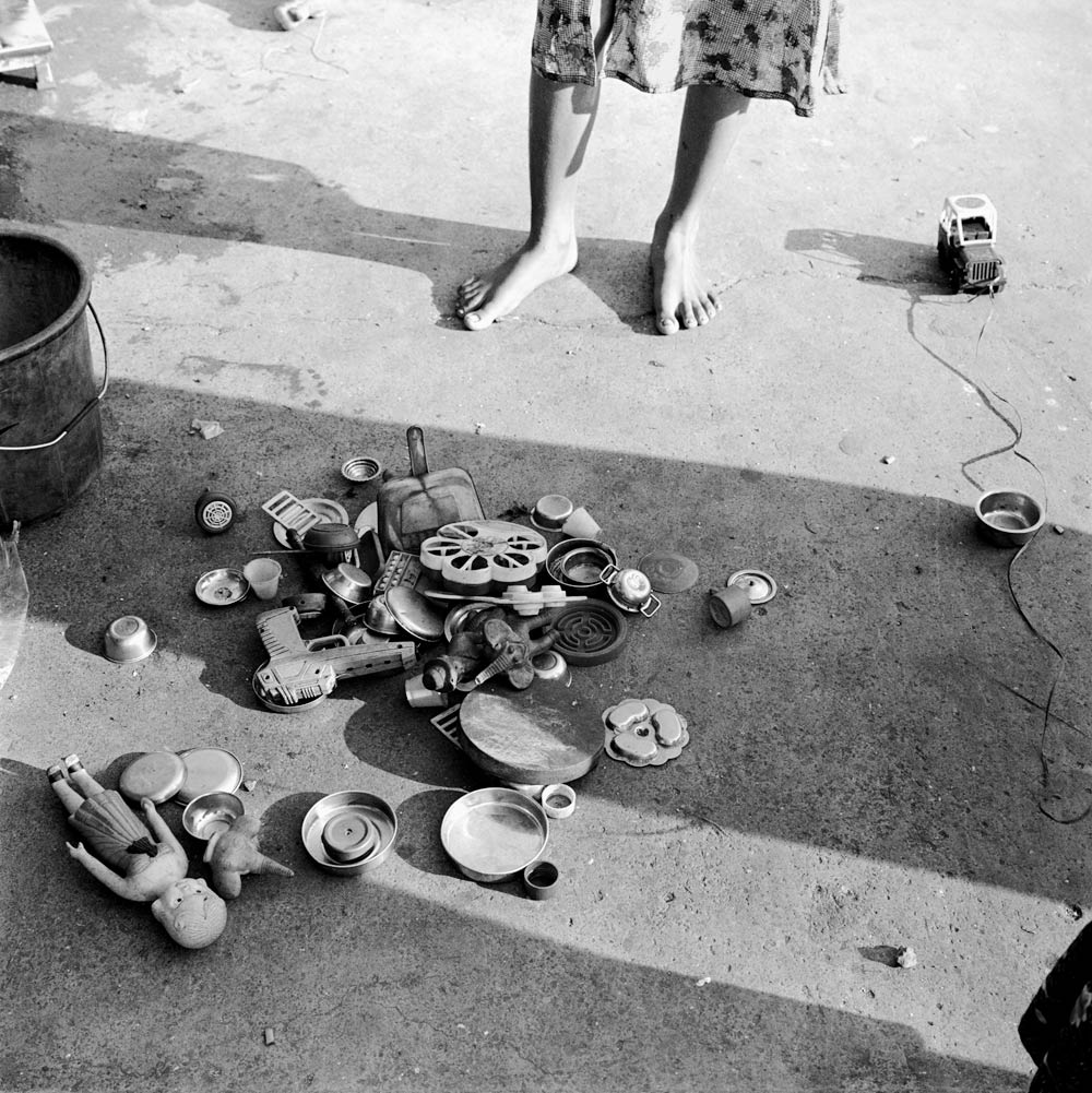 Toys, metalware and girl along P. D'Mello Road, Mumbai, Maharashtra.